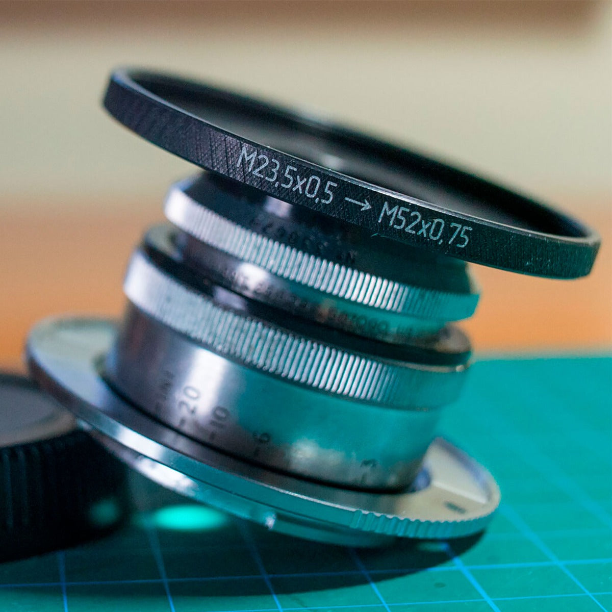 M23.5x0.5 male to M52x0.75 female filter step-up ring (Cooke Kinic 1.5/1″ lens)